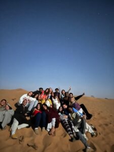 Morocco in your 20s, group under the Sahara night sky