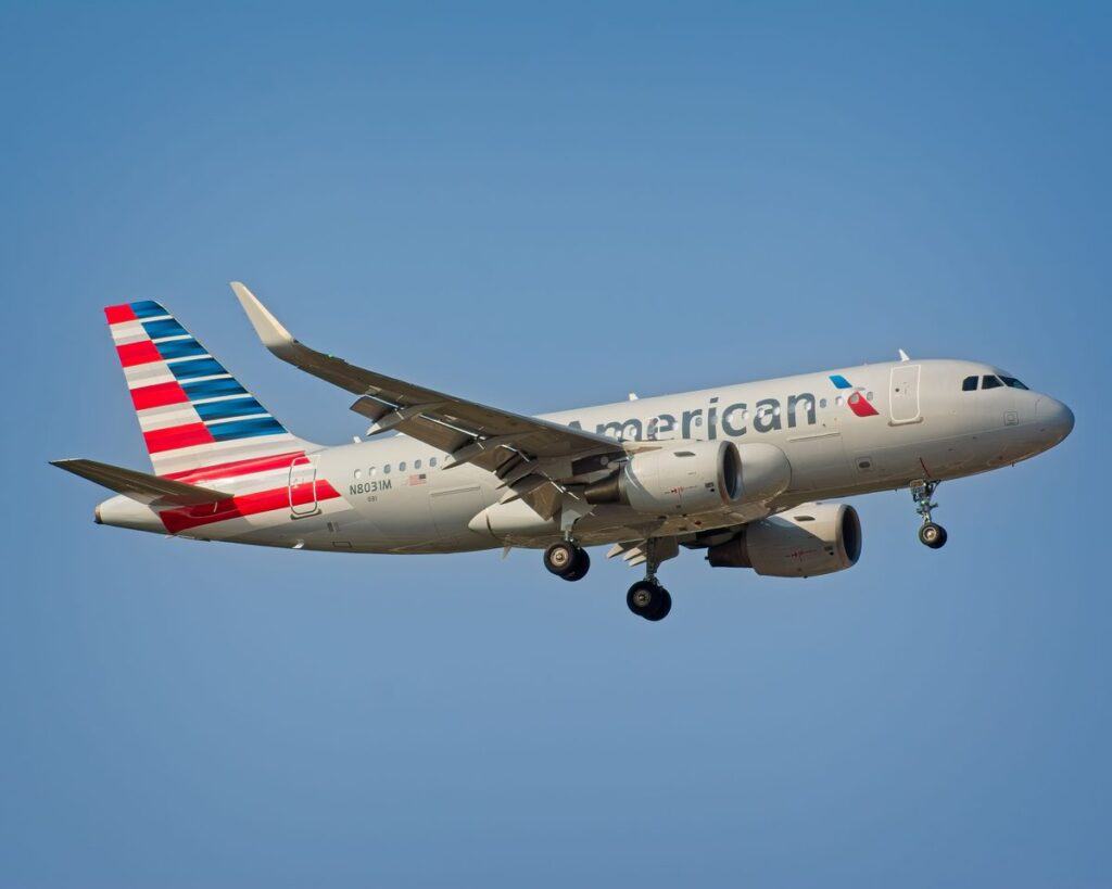 American Airlines aircraft in flight against a clear blue sky