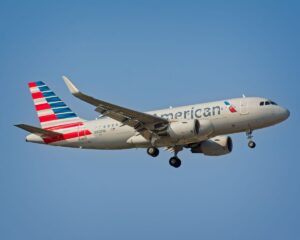 American Airlines aircraft in flight against a clear blue sky