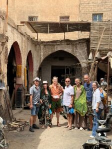 Group of travelers exploring an old kasbah alley in southern Morocco