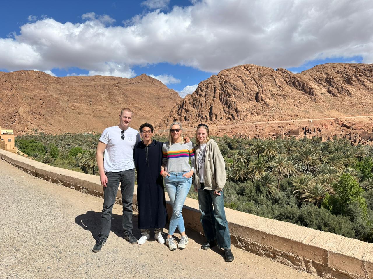 Travelers at a palm oasis viewpoint in southern Morocco