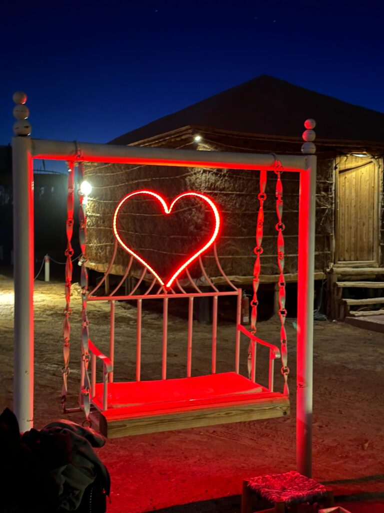 Lit-up heart swing at our desert camp at night, a festive spot for New Year in the Sahara