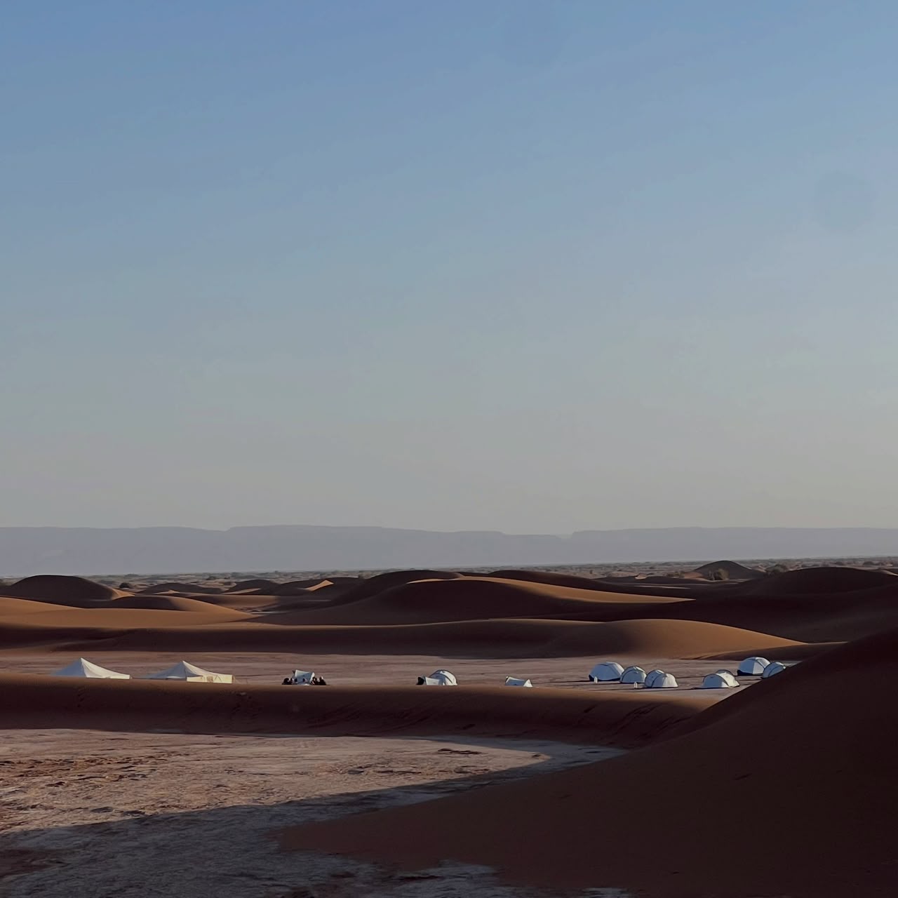 Desert camp among the Erg Chigaga dunes at dusk