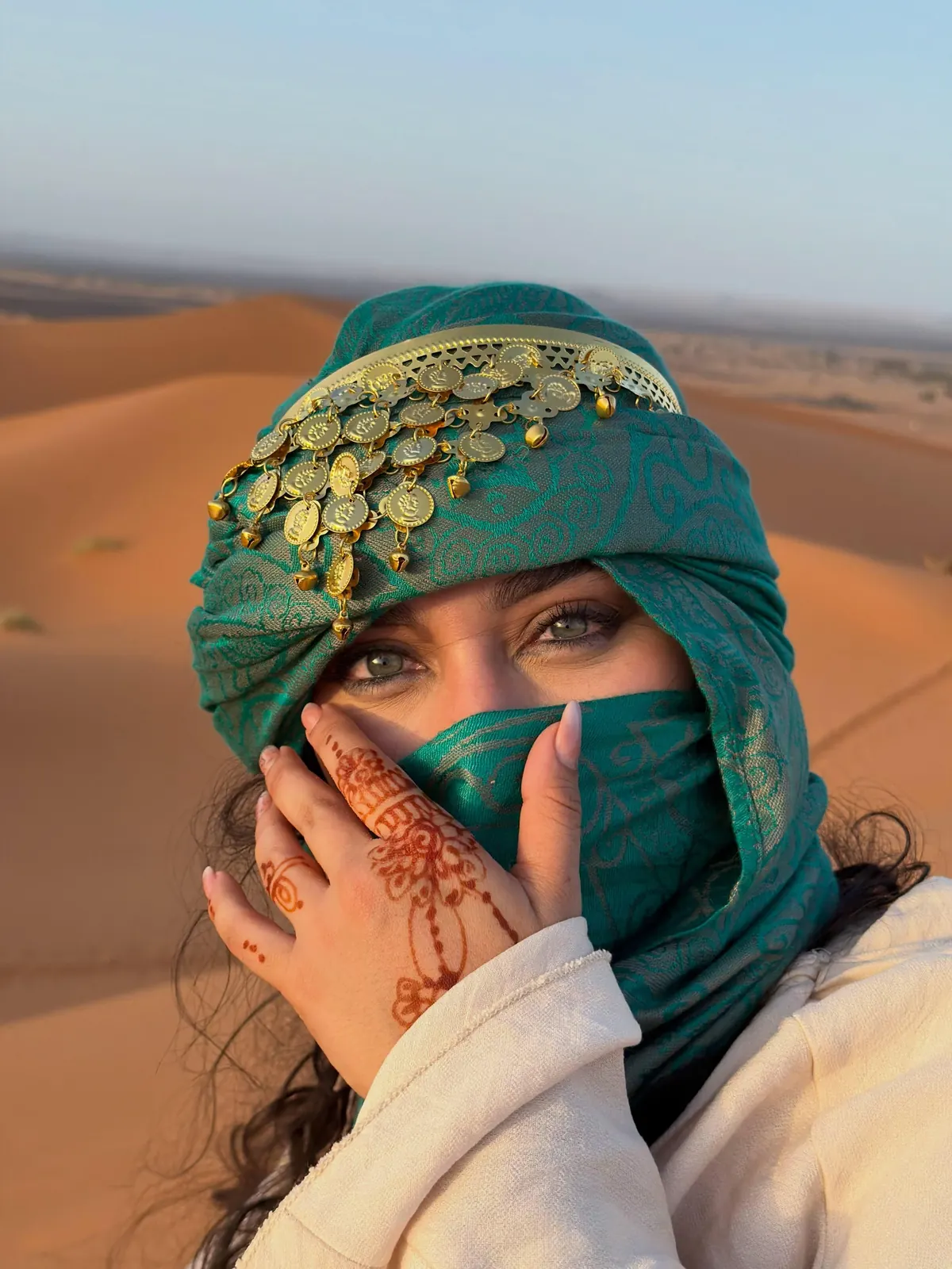Traveler wearing a Berber scarf and henna in the Sahara dunes