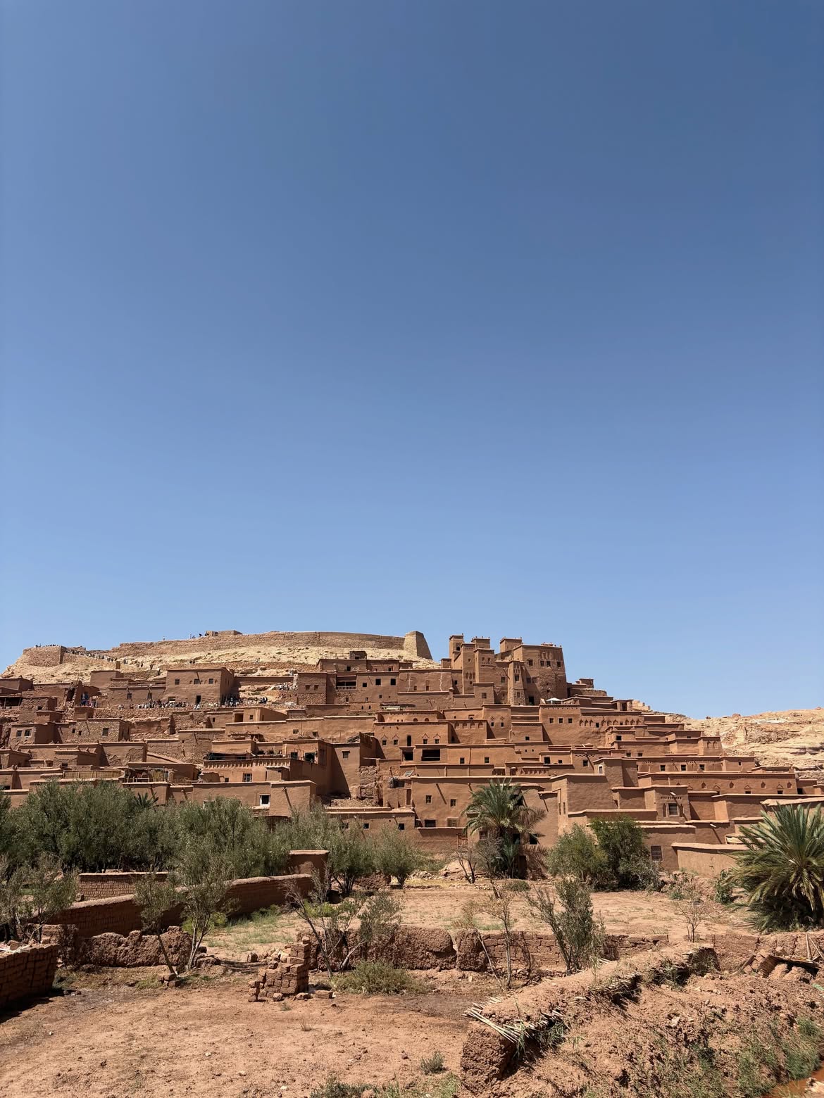 Ait Ben Haddou ksar built of red earth under a blue sky in southern Morocco