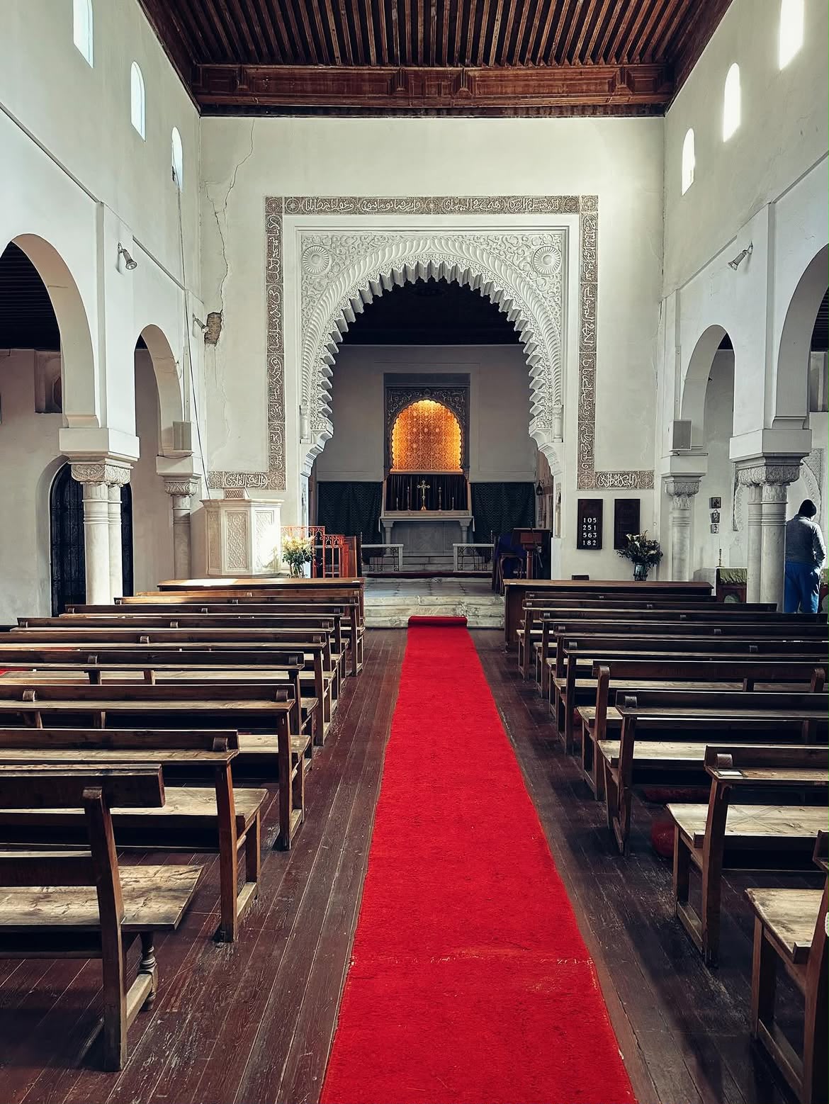 Interior of St Andrew's Anglican Church in Tangier with Moorish horseshoe arches and a carved wooden ceiling