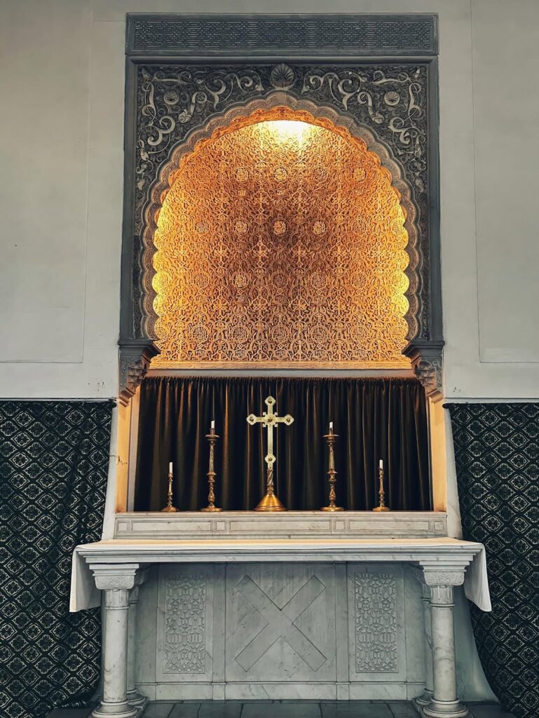 Altar niche with Moroccan carved plaster and a gold cross at St Andrew's Church Tangier