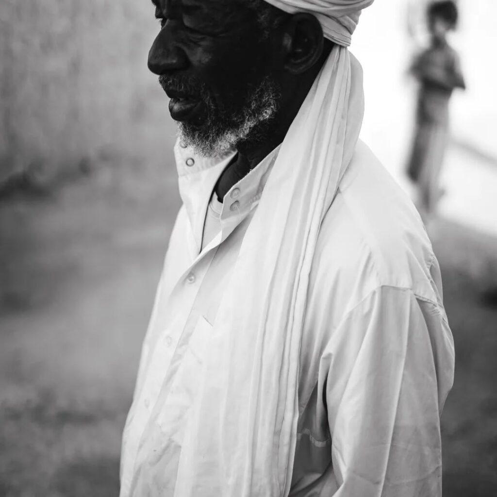 Portrait of an elderly Gnawa musician in a white turban, black and white photo