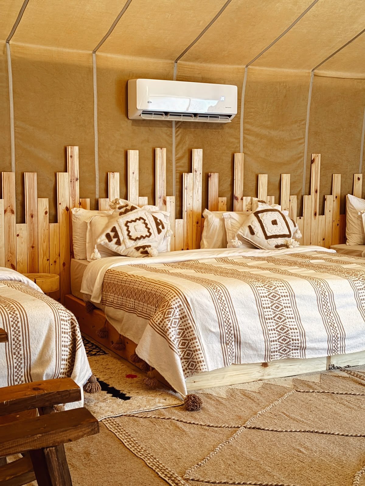 Luxury desert camp tent with a double bed, Berber-pattern linens and air conditioning