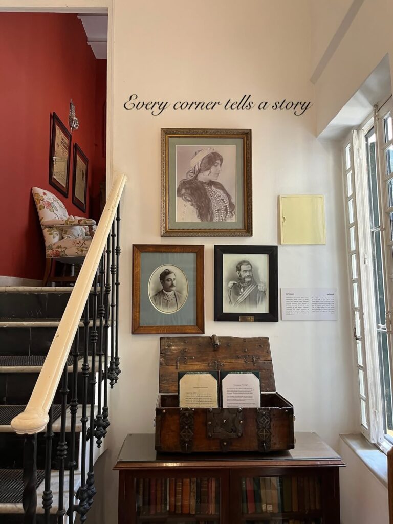 Staircase with historic portraits and an antique chest at the Tangier American Legation museum in the Tangier medina